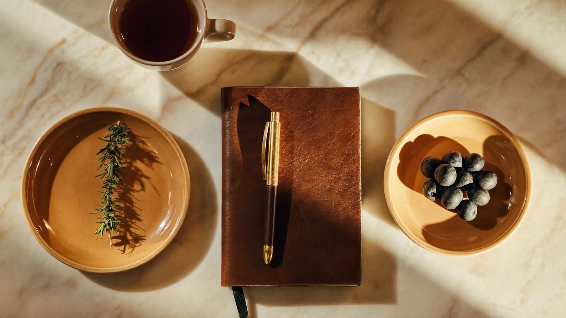 A clean side-by-side editorial composition with sage, berries, a leather notebook and tea — a thoughtful comparison.